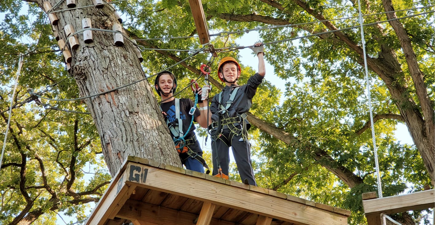 campers on a zipline in a tree