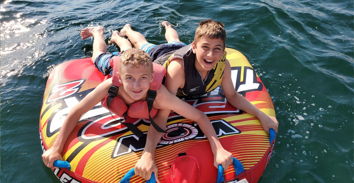 two campers on a raft in a lake