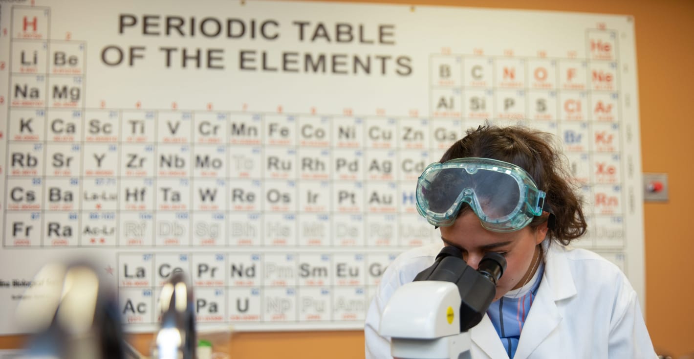 female student with microscope	