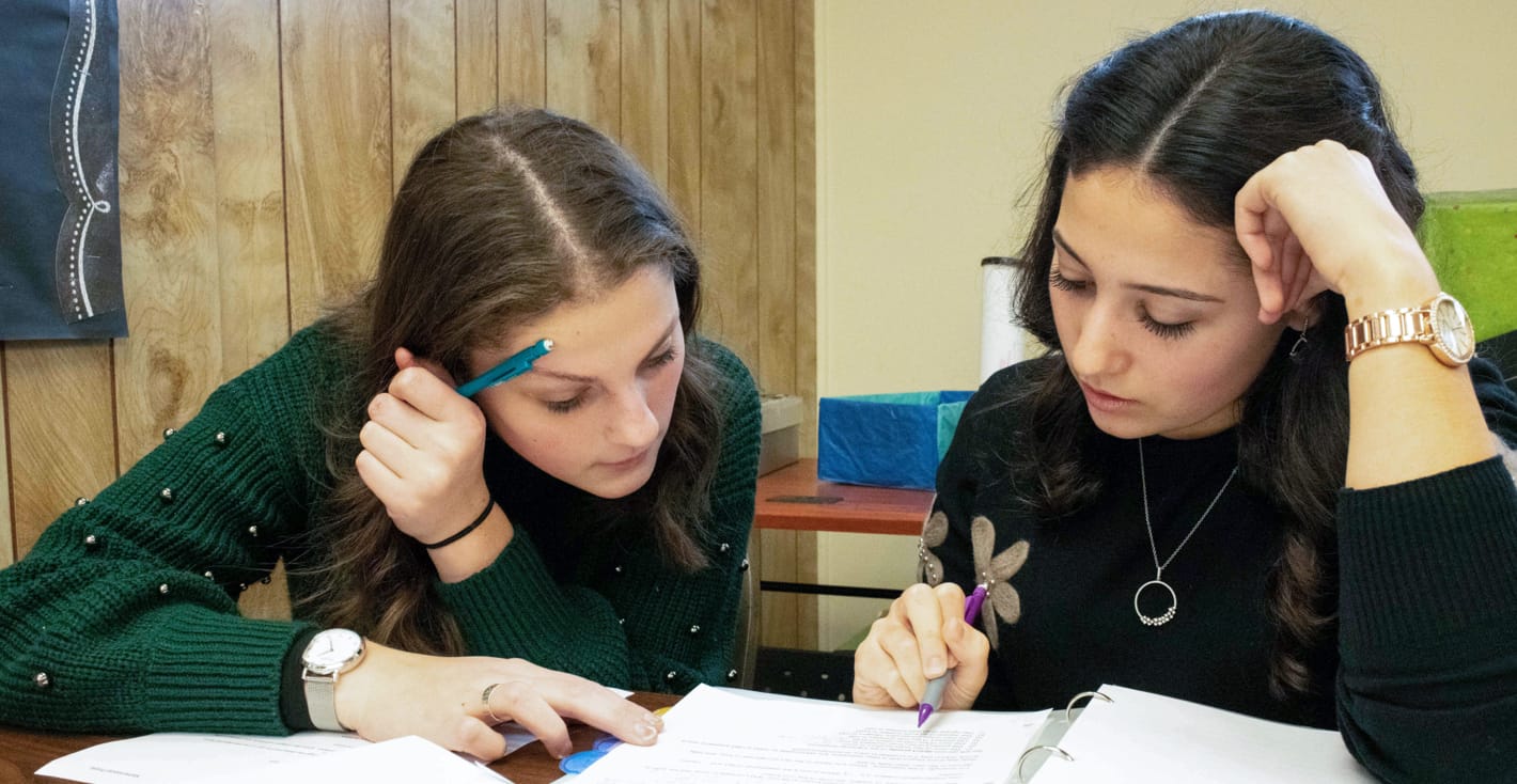 two female students doing school work