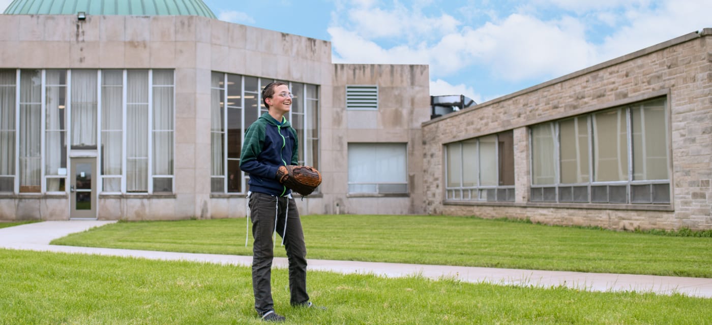 male student with baseball glove