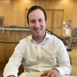 Rabbi Chaim Yosef Wenick sitting at table with religious text