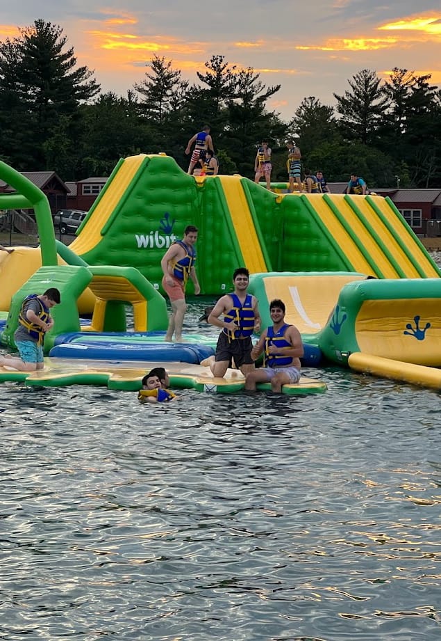 kids playing on rafts in a lake