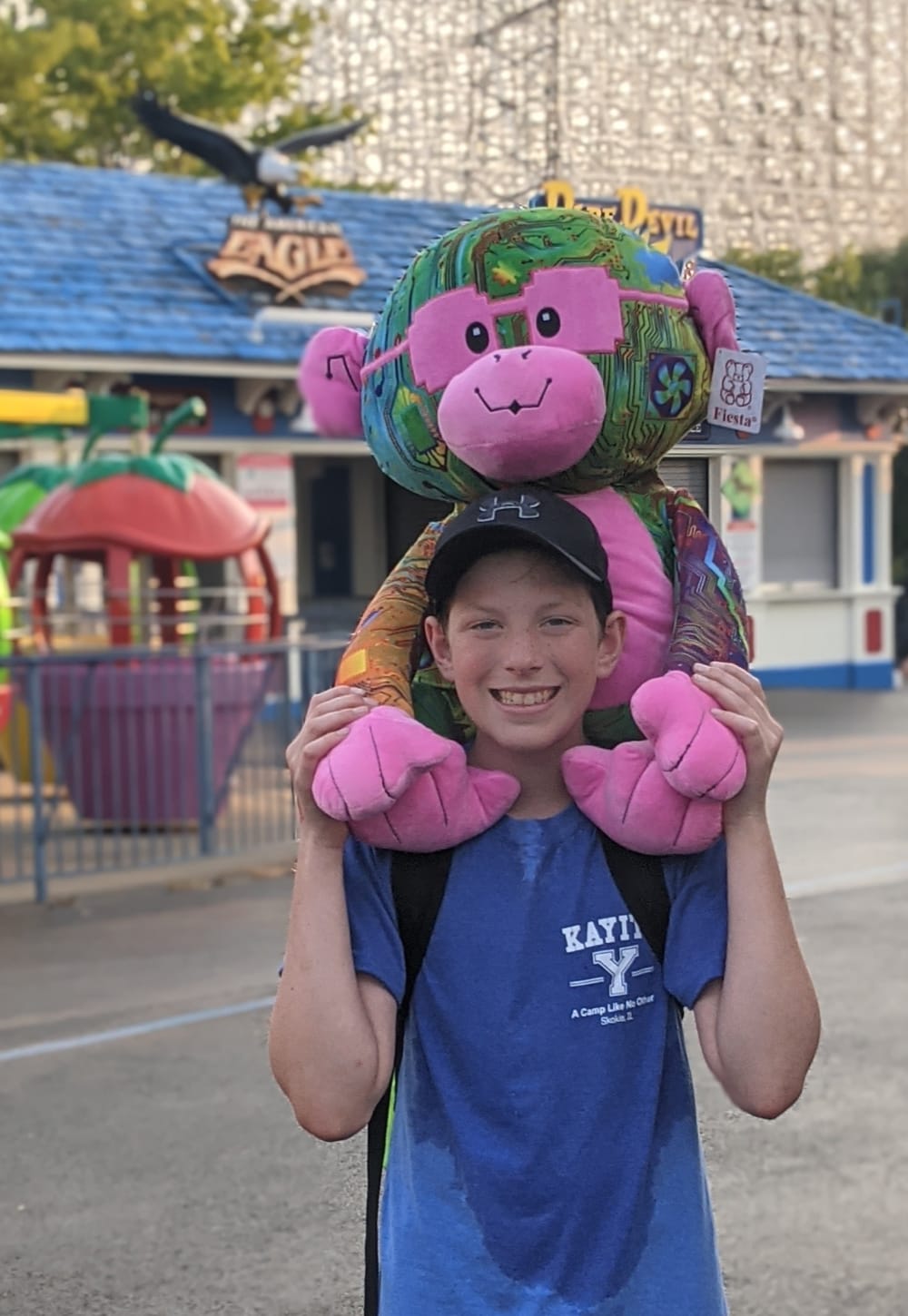 camper at a theme park with a teddy bear